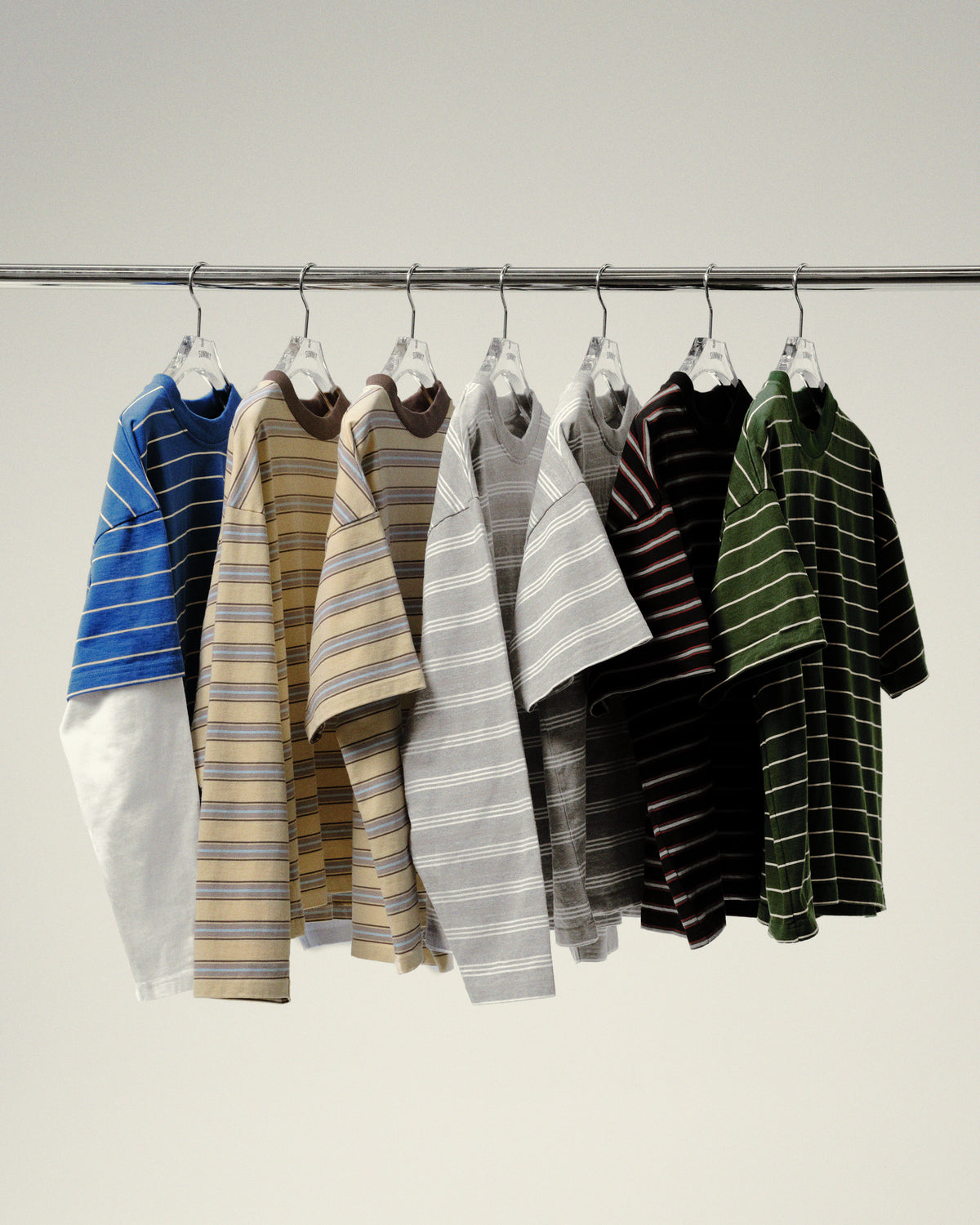 Summit striped polo shirts on a rail
